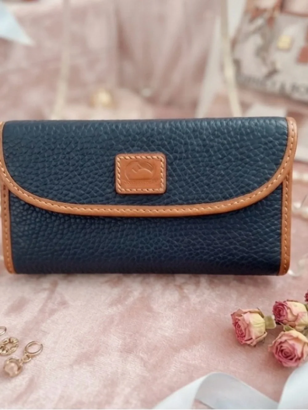 3 1/2”. X. 7”.  pebble-grain leather Dooney & Bourke Continental Clutch